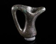 AN IRON AGE/GEOMETRIC BRONZE PENDANT IN THE SHAPE OF A JUG Circa 8th-6th century BC. Solid pendant in the shape of an oinochoe with long neck and larg...