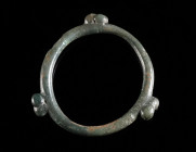A CELTIC BRONZE KNOBBED RING ('NOPPENRING') Circa 2nd-1st century BC. Ring with three groups of three knobs/globules. Diameter 28 mm

Ex European priv...