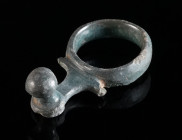 A CELTIC LATE LA TENE BRONZE SWORD BELT HOOK Circa 2nd-1st century BC. Belt hook with ring and knob ('Ringgürtelhaken'). Beautiful blue-green patina, ...