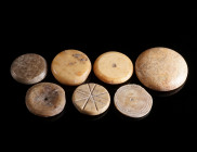 A GROUP OF SEVEN ROMAN BONE GAMING PIECES Circa 1st-4th century AD. Different shapes, some with decoration. Diameter 16-23 mm

Ex European private col...