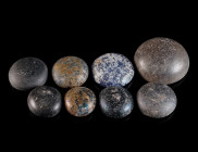 A GROUP OF EIGHT ROMAN GLASS GAMING PIECES Circa 1st-4th century AD. Opaque blue glass and dark glass (black in appearance). Diameter 14-25 mm

Ex Eur...
