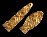TWO ROMAN GOLD VOTIVE LEAFS Circa 2nd-3rd century AD. Made of thin sheet metal with punched linear decoration. Slightly bent. L 32 mm, and L 40 mm; Go...