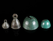 A GROUP OF FOUR LATE ROMAN/BYZANTINE BRONZE BELLS Circa 4th-7th century AD. Four small conical or hemispherical bells, decorated with incised horizont...