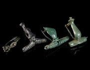 A GROUP OF FOUR ANCIENT BRONZE BROOCHES Circa 1st century BC - 3rd century AD. Mostly Roman; various forms. With spring and pin or hinged pin. L 22-32...
