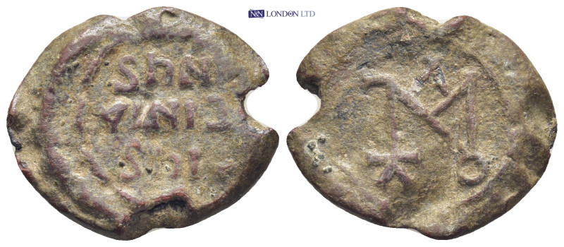 Byzantine Lead Seal (24mm, 8.9 gr) Obv: Legends in three lines. Rev: Cruciform m...