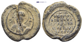 Byzantine lead seal (6.3Gr. 20mm.) Obv: Nimbate facing bust of Saint, holding spear over his right shoulder and shield on his left arm. Rev: Legends i...