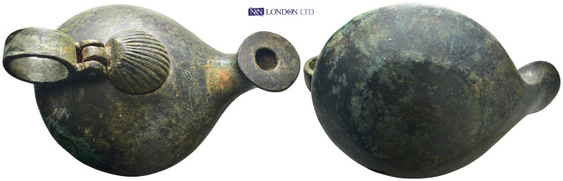 Bronze lamp with carinated body and round-topped nozzle. Has a lid in shape of s...