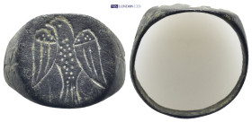 Bronze ring. A bronze D-shaped finger ring with ellipsoid plaque, intaglio eagle with wings spread and head turned. (19mm, 4.66 g)