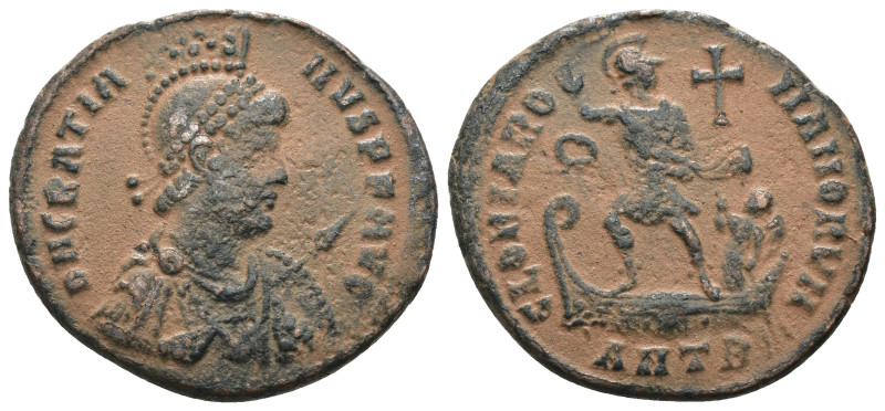 Gratian. (392-395 AD). Follis. Antioch. Obv: D N GRATIANVS P F AVG. helmeted and...