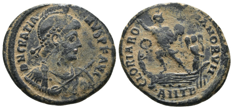 Gratian. (392-395 AD). Follis. Antioch. Obv: D N GRATIANVS P F AVG. helmeted and...