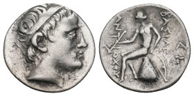 SELEUKID KINGDOM. Antiochos II Theos (261–246 BC). Drachm. Tralles (?).
Obv: Diademed head right.
Rev: BAΣIΛEΩΣ ANTIOXOY.
Apollo seated left on omphal...