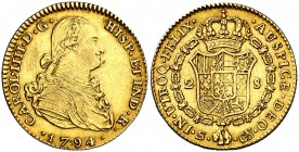 1794. Carlos IV. Sevilla. CN. 2 escudos. (Cal. 446). 6,74 g. Rayitas en anverso. MBC+.