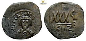 Phocas, AD 602-610. AE, Follis. 9,9 g. 31,4 mm. Cyzicus.Obv: D N FOCAS PЄRP AVG. Crowned bust facing, wearing consular robes and holding mappa and cro...