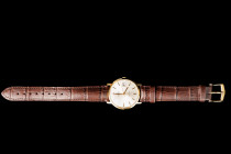 Gold 14K. Time plus date. Authentic alligator embossed leather strap. The 2nd half of the 20th century. Diameter 3,2 cm. The watch is fully functional...