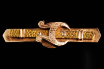 A gold brooch, form of a belt with a buckle. Two color gold, Russian style. Marked 56. Russian Empire. The end of the 19th century. The reign of Emper...