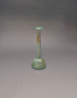 ARQUEOLOGÍA. ROMA. Ungüentario de cuerpo semiglobular y cuello alargado con boca exvasada (ss. I-IV d.C.). Vidrio con irisaciones. Altura 17 cm.

Ex...