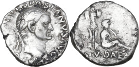 Vespasian (69-79). AR Denarius, 69-70 AD. Obv. IMP CAESAR VESPASIANVS AVG. Laureate head right. Rev. Judaea seated to right against trophy; IVDAEA in ...