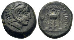 Macedon, Philippi, c. 356-345 BC. Æ (17,3mm, 6.70g.). Head of Herakles right, wearing lion skin without paws / Tripod; laurel branch above, grape bunc...