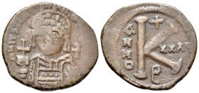 Justinian I (527-565). Æ 20 Nummi (27mm, 8.51g, 11h). Theoupolis (Antioch), year 32 (558/9). Helmeted and cuirassed bust facing, holding globus crucig...