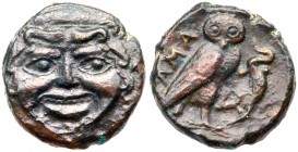 Sicily, Kamarina. &AElig; Onkia (1.44 g), ca. 420-405 BC. Gorgoneion facing. Reverse: KAMA, owl standing right, head facing, grasping lizard; in exerg...