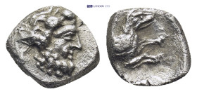 LYCAONIA. Laranda. Obol (Circa 324/3 BC. (0.62 Gr. 9mm.)
Head of Herakles right. 
Rev. Forepart of wolf right; inverted crescent above.