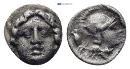Pisidia. Selge circa 350-300 BC. Obol AR (0.86 Gr. 9mm.) 
Gorgoneion. 
Rev. Head of Athena to right, wearing crested Attic helmet.
