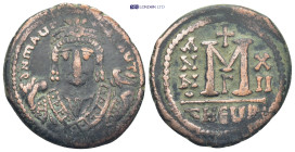 TIBERIUS. 582-602 AD. AE Follis. Antioch mint. (11.6 Gr. 28mm.)
Crowned facing bust in consular robes, holding mappa and eagle-tipped sceptre 
Rev. La...