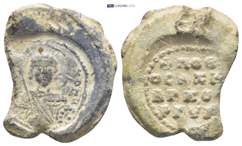 Byzantine Lead Seal (11.7 Gr. 27mm.). Obv: Nimbate facing bust of Saint, holding...