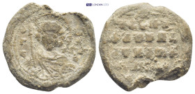 Byzantine Lead Seal (9.98 Gr. 23mm.). Obv: Nimbate facing bust of Saint, holding a spear over his left shoulder, and resting a shield on his left arm ...