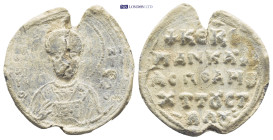 Byzantine Lead Seal (5.0Gr. 24mm.). Obv: Nimbate facing bust of Saint, holding gospel. Rev: Legends in four lines.
