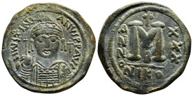 JUSTINIAN I (527-565). Follis. Nicomedia.
Obv: D N IVSTINIANVS P P AVG.
Helmeted, draped and cuirassed facing bust, holding globus cruciger and shield...
