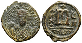 Phocas, 602-610. Follis. Theoupolis (Antioch). Crowned bust facing, wearing consular robes, holding mappa and eagle-tipped scepter. Rev. Large m; cros...