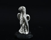 Roman Silver Eagle Pendant. 1st-2nd century AD. A silver pendant of an eagle perching with wings slightly spread, loop to the reverse.
Condition : See...