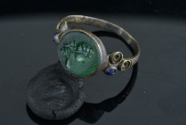 Roman Ring decorated with blue stones around it.
flat bezel set with green stone intaglio engraved with the a bust.
Condition : See picture. No retu...