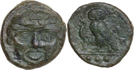 Sicily. Kamarina. AE Tetras, 425-405 BC. Obv. Gorgoneion. Rev. Owl standing left, head facing, wings closed, holding lizard in claws; in exergue, thre...