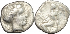 Greek Italy. Bruttium, Terina. AR Drachm, c. 300 BC. D/ Female head left; behind, triskeles. R/ Nike seated left on cippus, holding bird. HN Italy 264...