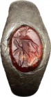 Silver ring, the bezel decorated carnelian intaglio depicting standing figura holding bunch of grape (Dionysos?). Roman period, 2nd-3rd century AD. Si...