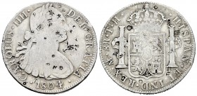 Carlos IV (1788-1808). 8 reales. 1804. México. TH. (Cal-701). Ag. 26,69 g. Resellos orientales. BC+. Est...60,00.