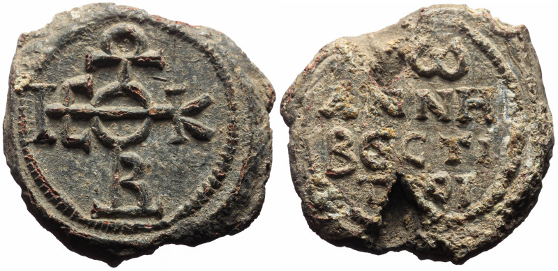 Byzantine Pb seal (12.28g, 25mm) John vestitor (eighth century)
Obv: Cruciform ...