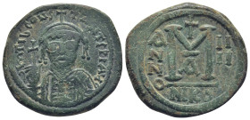 Tiberius II Constantine AD 578-582. Nikomedia Follis Æ (32mm., 15,0 g). Helmeted and cuirrased facing bust, holding globus cruciger and shield with ho...