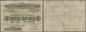 Ceylon: 5 Rupees 1919 P. 11b, used with folds and creases, stained paper, holes in paper which are partially fixed on back side, condition: VG.
