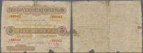 Ceylon: 5 Rupees 1914 P. 11b, rare larger size note in used condition with several folds and creases, light stain in paper, missing parts at lower bor...