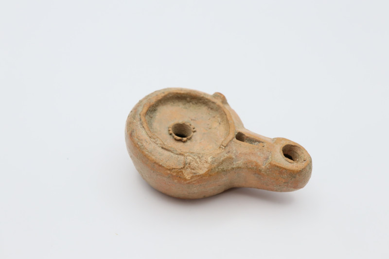 Roman Ceramic Lamp 1st- 3rd Century AD

Ceramic lamp with oval body and extend...