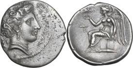 Greek Italy. Bruttium, Terina. AR Drachm, c. 300 BC. Obv. ΤΕΡΙΝΑΙΩΝ. Head of nymph right; triskeles behind. Rev. Nike seated left on cippus, holding b...