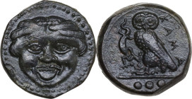 Sicily. Kamarina. AE Tetras, 425-405 BC. Obv. Gorgoneion. Rev. KAMA. Owl standing left, head facing, wings closed, holding lizard; in exergue, three p...