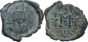 Constantine IV Pogonatus, with Heraclius and Tiberius (668-685). AE Follis. Syracuse mint. Struck 669-672 AD. Obv. Helmeted and cuirassed facing bust,...
