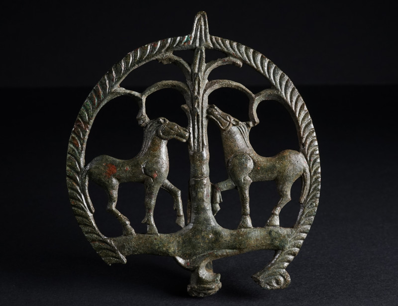 A ROMAN BRONZE CHARIOT FITTING WITH TWO HORSES
Circa 2nd-3rd century AD.
Elabo...