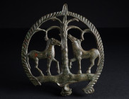 A ROMAN BRONZE CHARIOT FITTING WITH TWO HORSES
Circa 2nd-3rd century AD.
Elaborately decorated high-quality openwork fitting with two horses and a p...