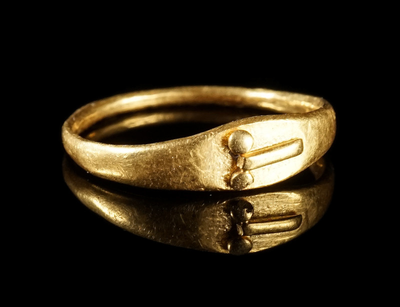 A ROMAN GOLD RING WITH A PHALLUS
Circa 1st-2nd century AD.
Small ring with ova...