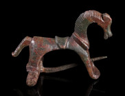 A LARGE ROMAN BRONZE HORSE BROOCH
Circa 2nd-3rd century AD.
Fine brooch in the shape of a stylised horse with saddle; worked three-dimensional with ...